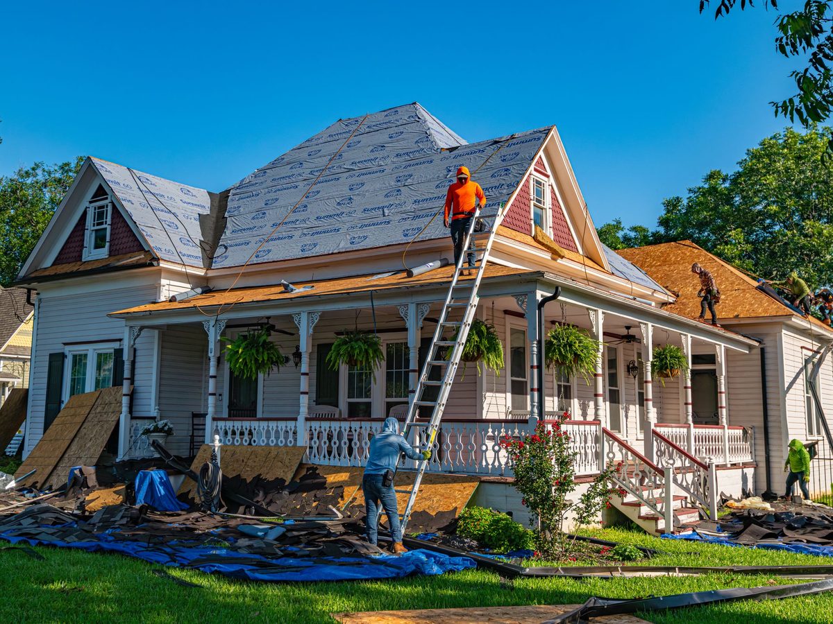 Roof replacement in progress on an older two story home